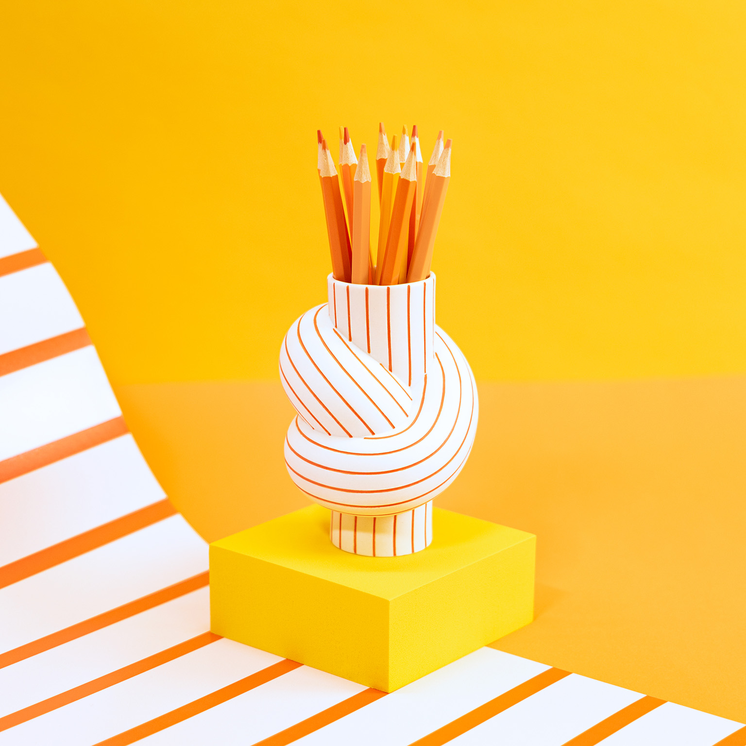Nodes Stripes Mango filled with orange crayons against a yellow background with white and orange stripes.